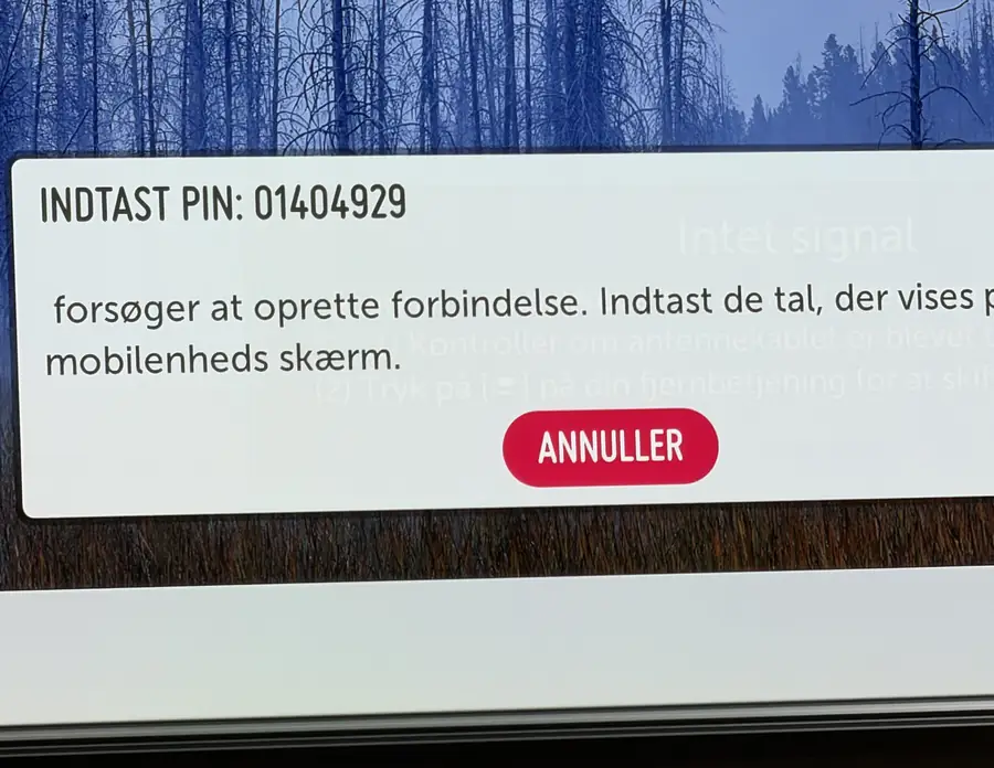 An LG TV showing a dialog with an eight digit pairing PIN and a cancel button