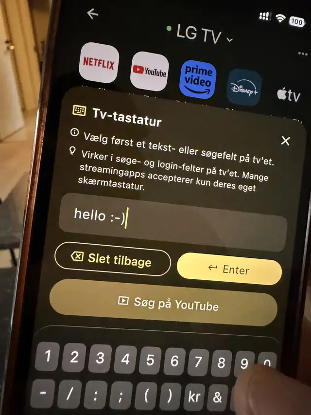 The TV keyboard sheet in the app with a phrase typed in, above a Search on YouTube button