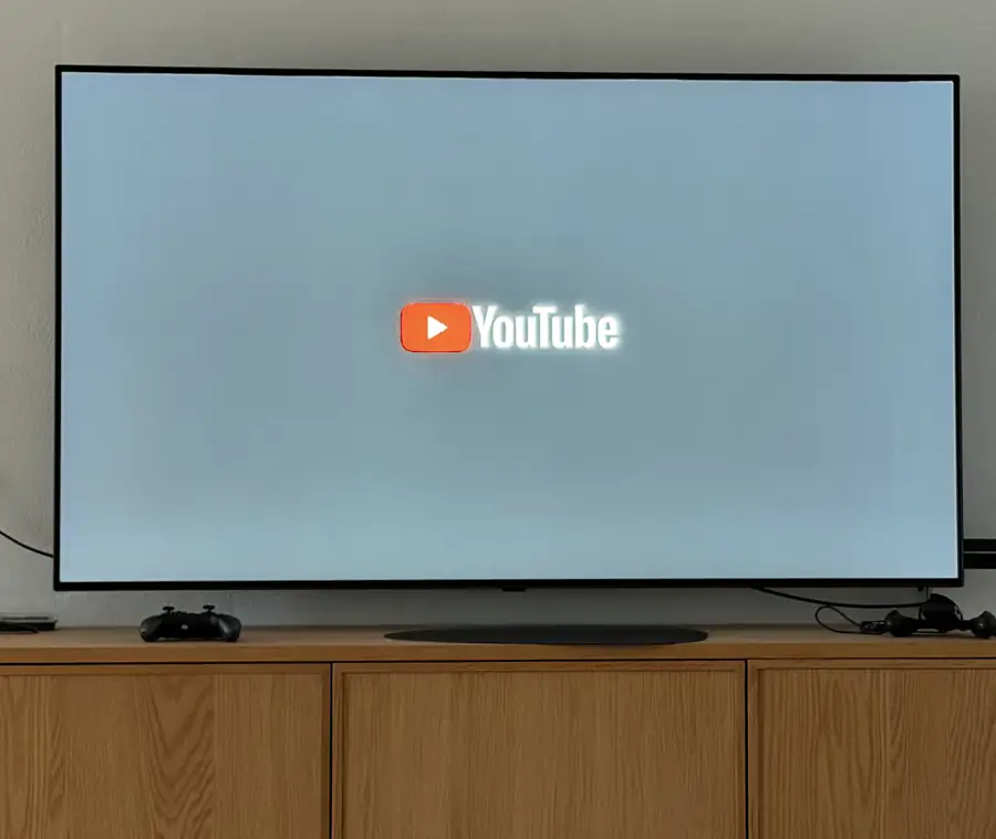 An LG TV showing the YouTube splash screen as the app relaunches